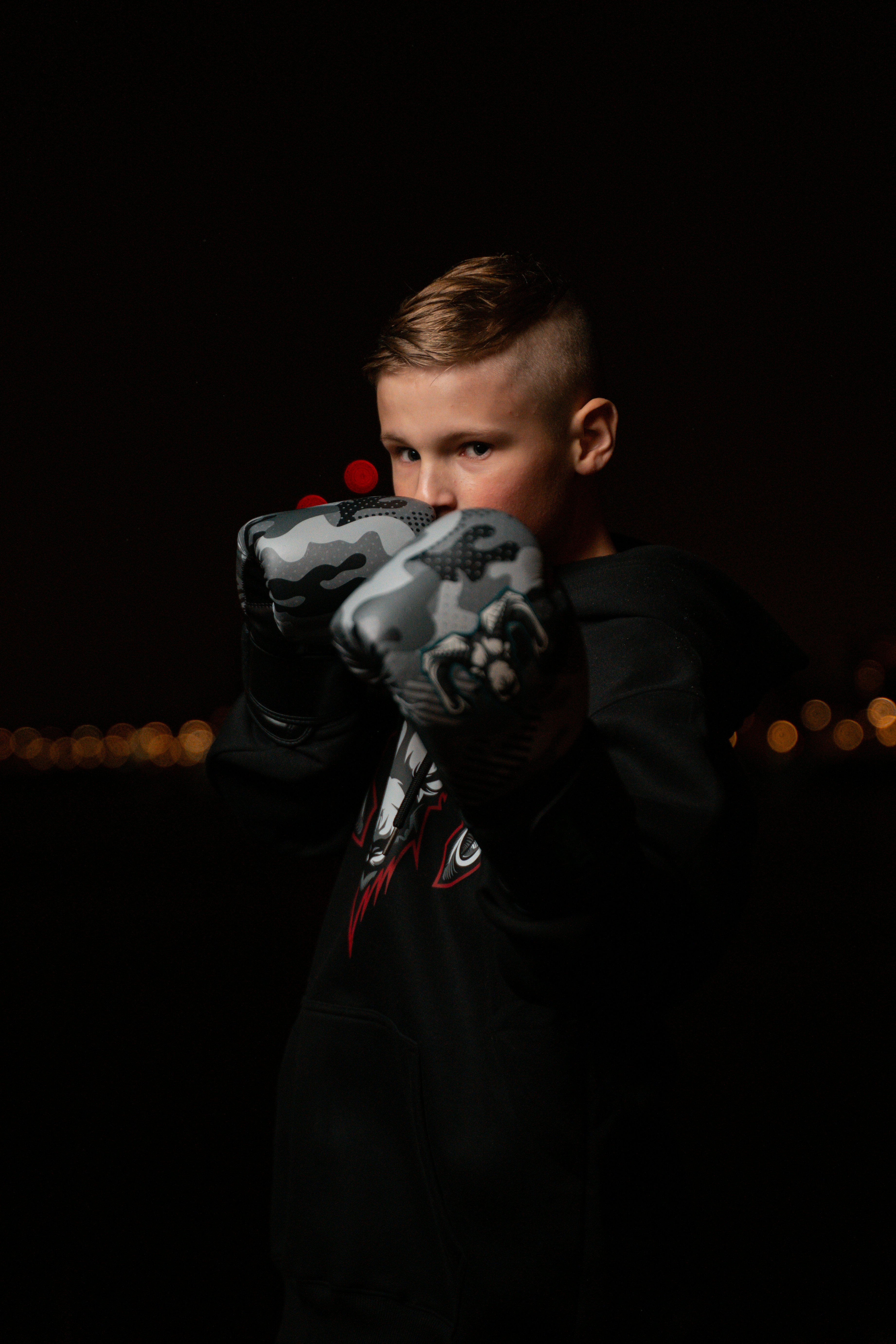 A young boy holding a gun in his hands