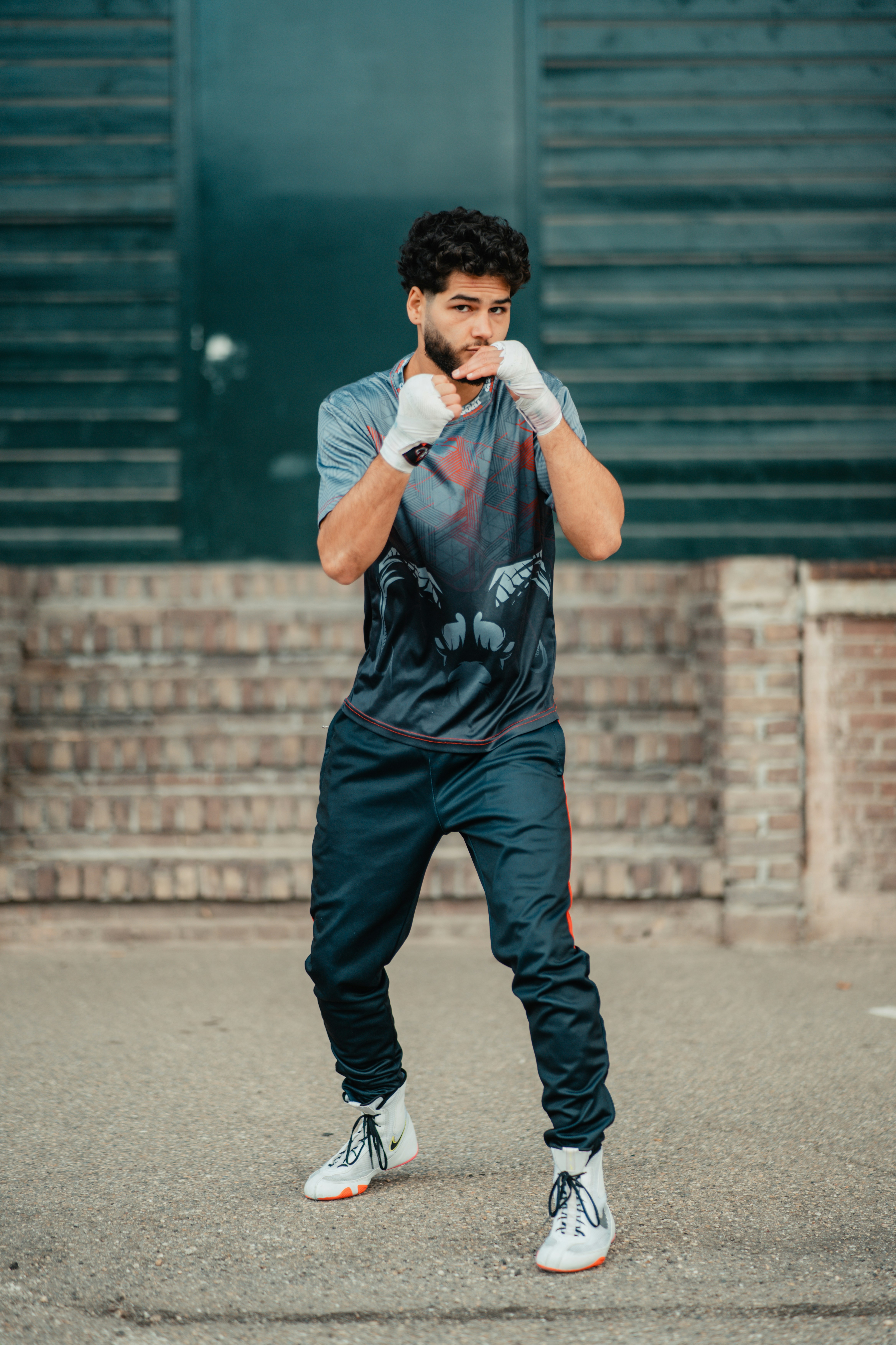 A man standing in a parking lot with his hands on his face