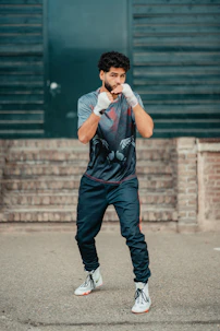 A man standing in a parking lot with his hands on his face