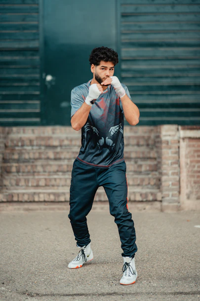 A man standing in a parking lot with his hands on his face