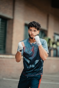 A man with boxing gloves on running in the street