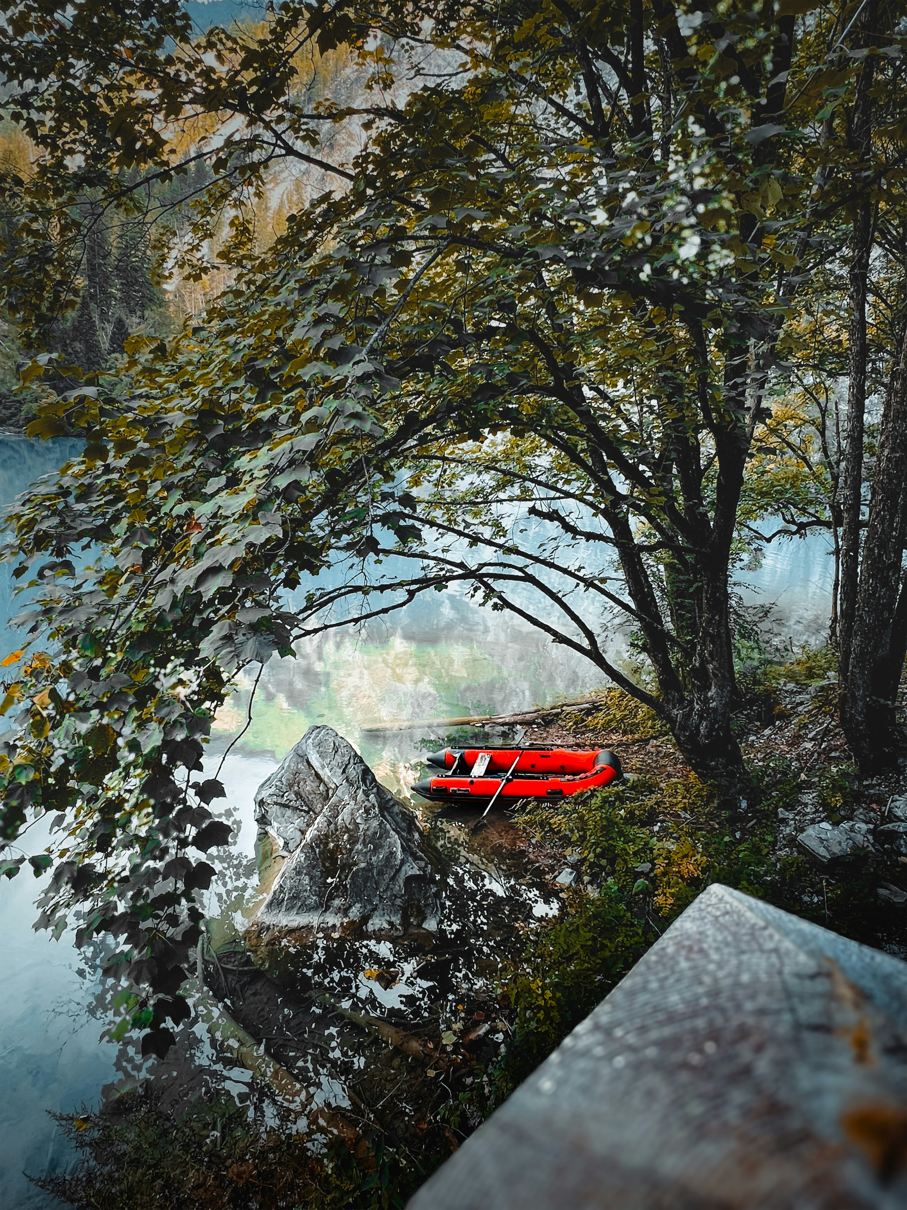 A painting of a red boat on a river