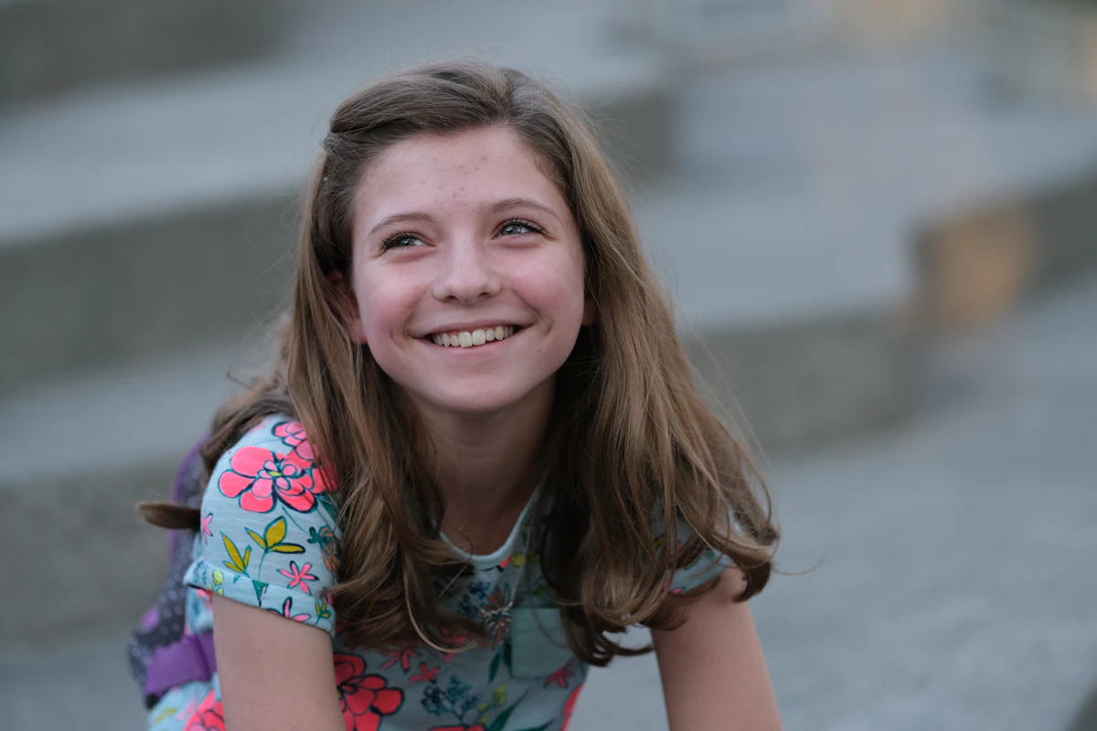 Smiling teenage girl sitting on steps