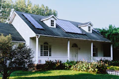 A small white house with a black roof