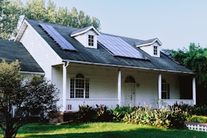 A small white house with a black roof