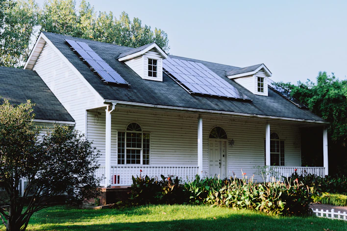 A small white house with a black roof