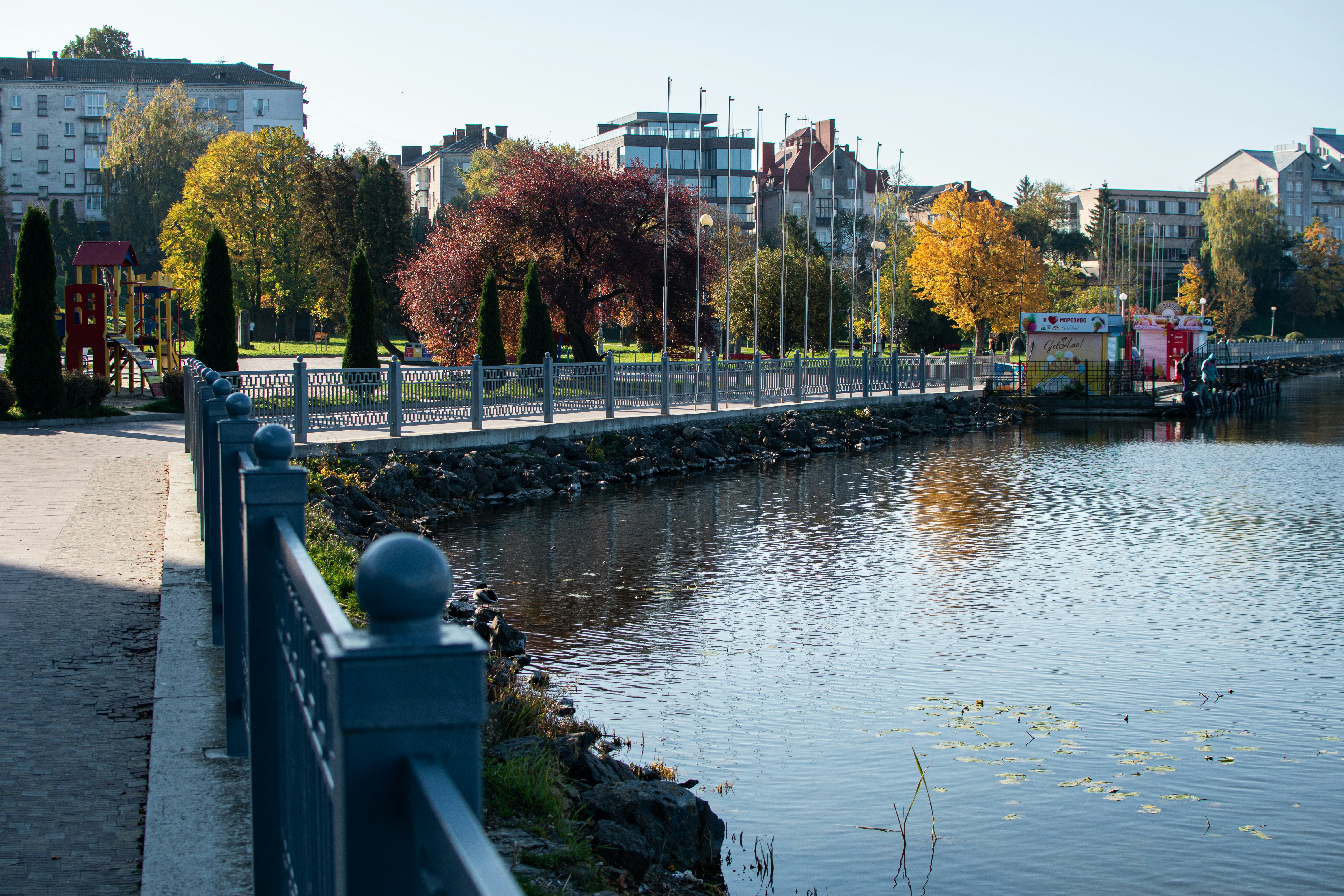 A body of water next to a city street