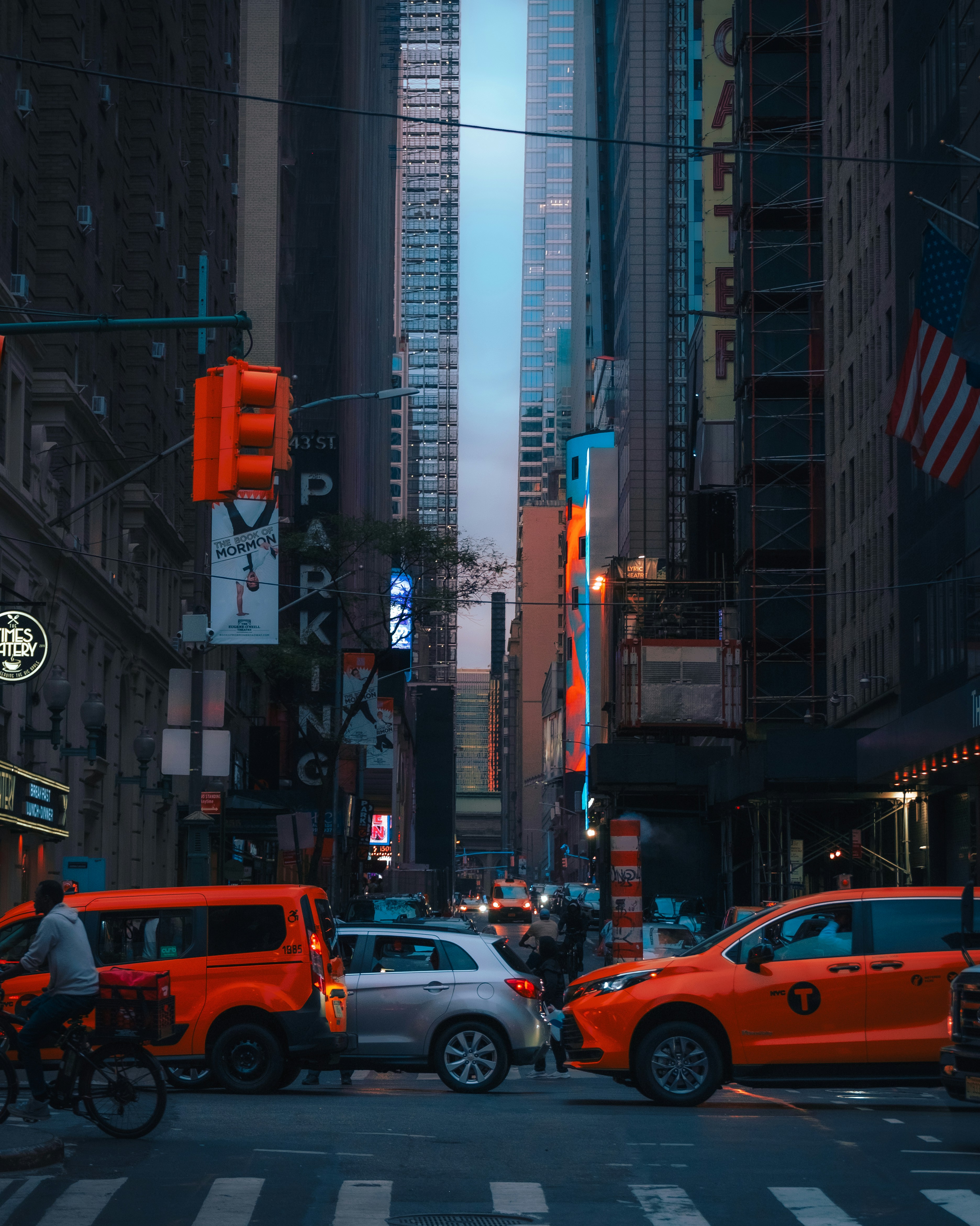 A city street filled with traffic and tall buildings