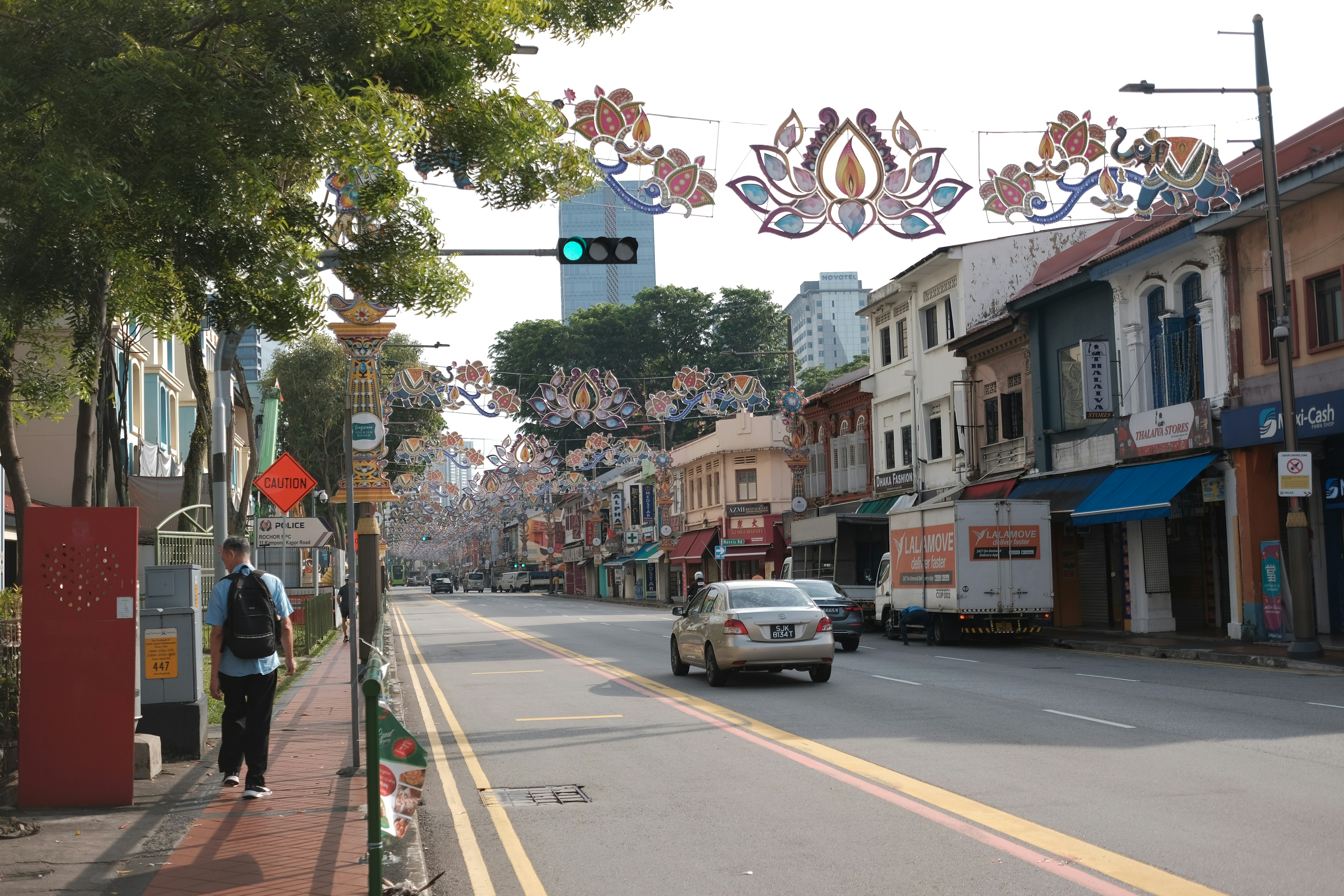 A car driving down a street next to tall buildings