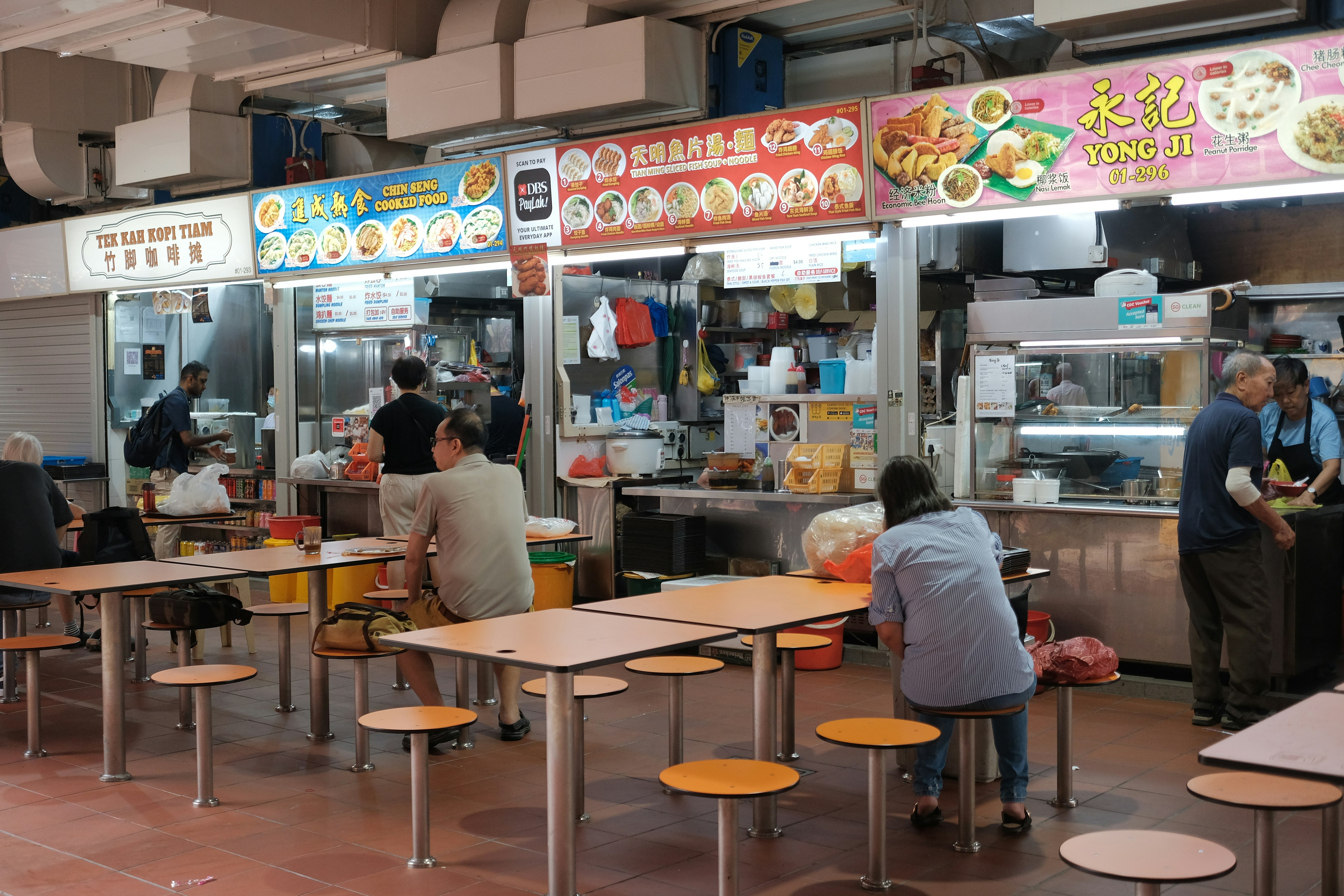 A group of people sitting at tables in a restaurant