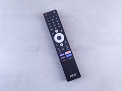 A close up of a remote control on a white surface