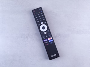 A close up of a remote control on a white surface