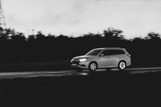 A car driving down a road next to a tower
