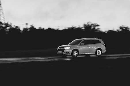 A car driving down a road next to a tower