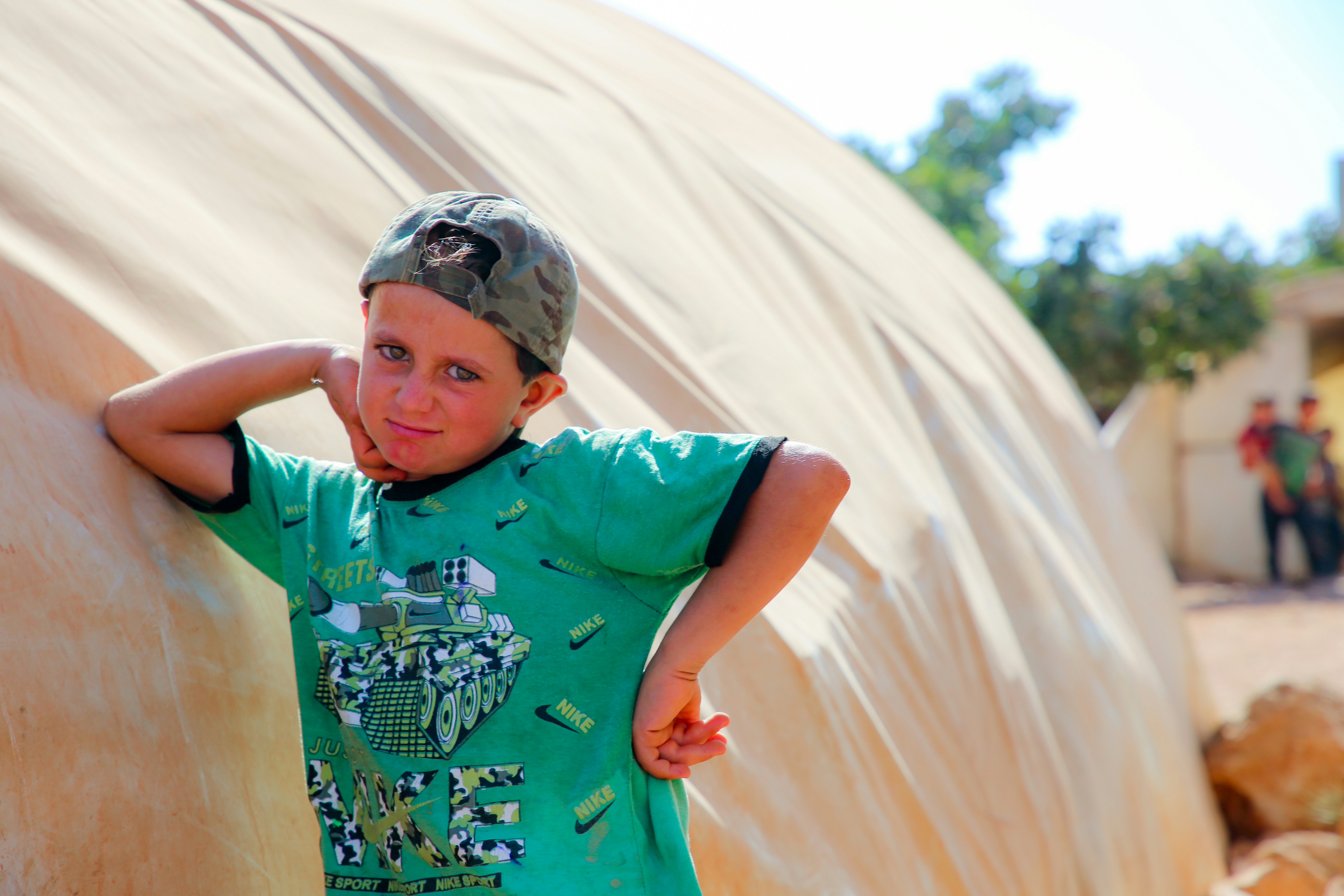 Ein kleiner Junge, der neben einem großen Gegenstand steht