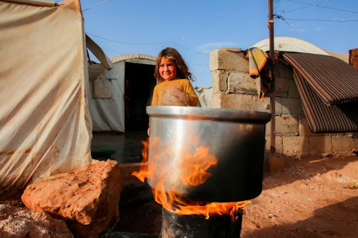 A woman is sitting in a pot on fire