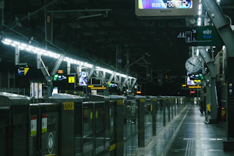 A train station with a lot of lights on the ceiling