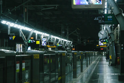 A train station with a lot of lights on the ceiling