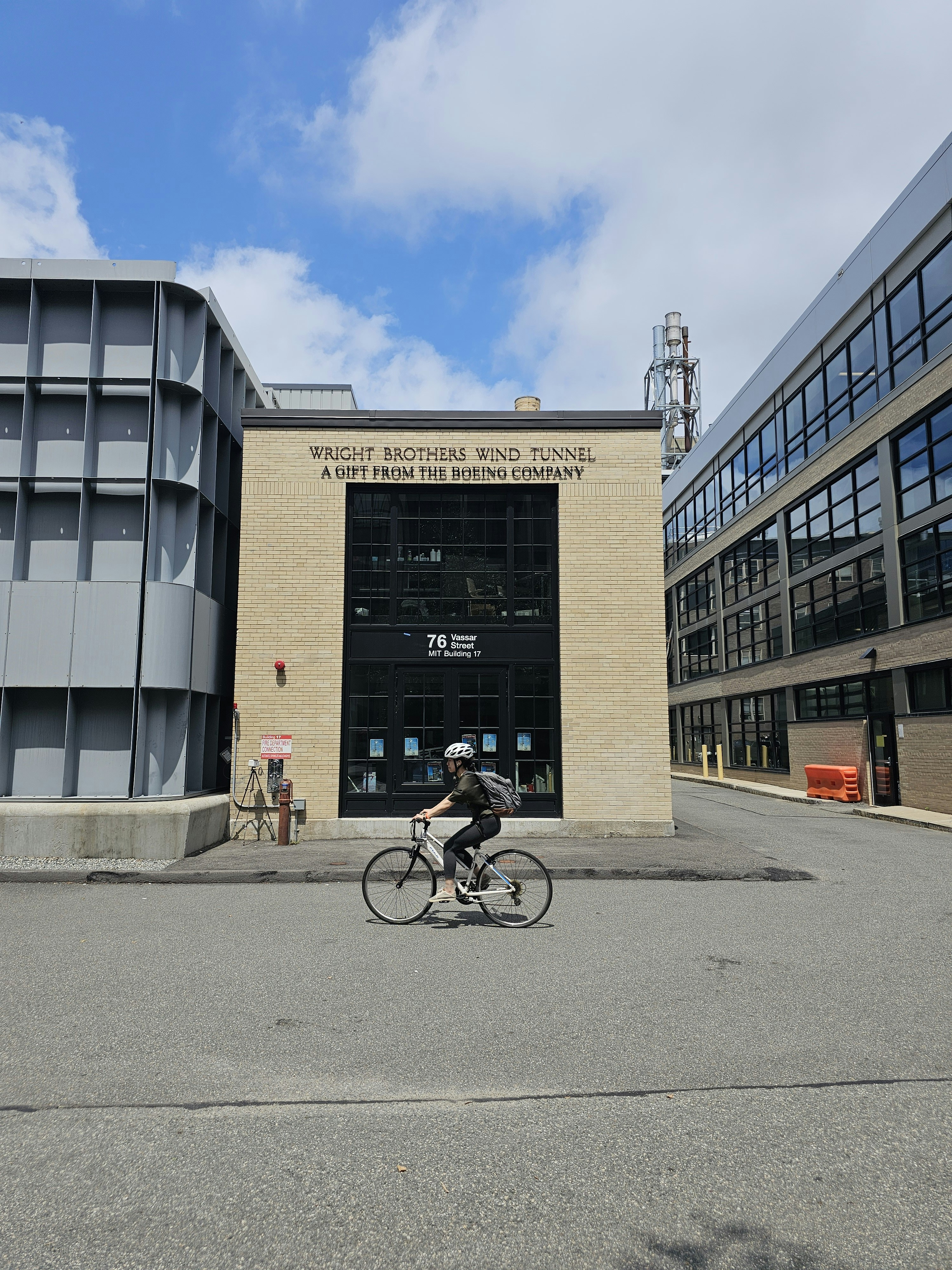 A person riding a bike in front of a building