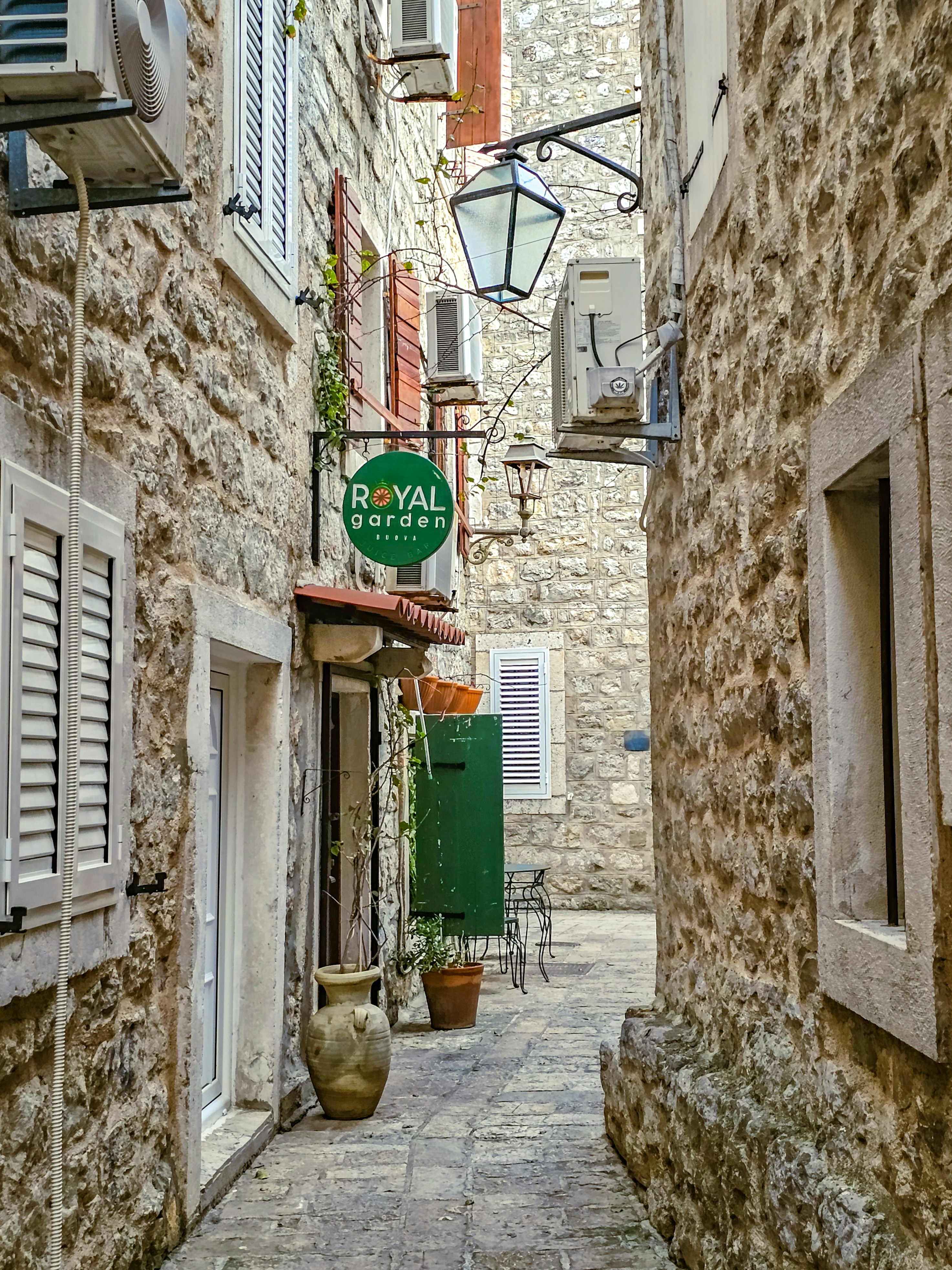 A narrow street with a sign on the side of it
