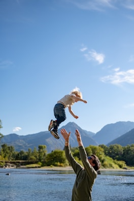 A man holding a child up in the air