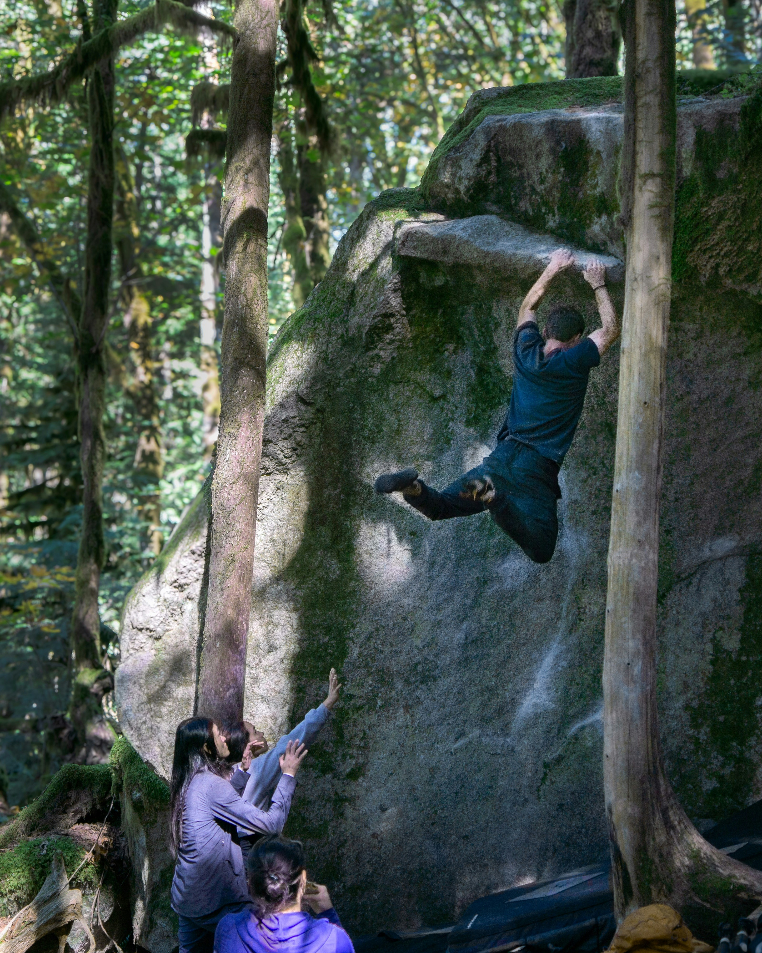 A boulderer leaping for a hold