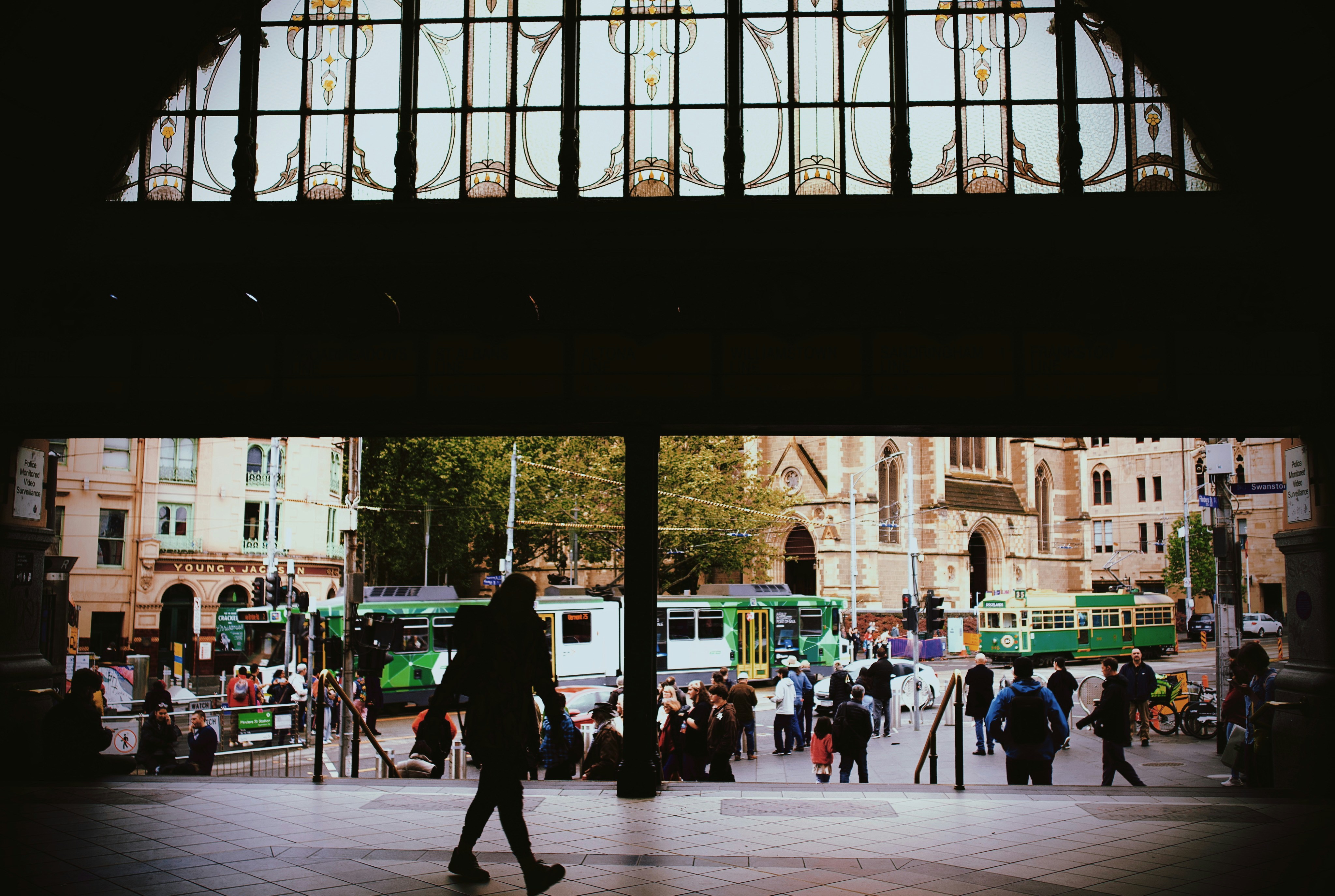 A group of people walking around a train station