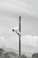 A black and white photo of a camera on a pole