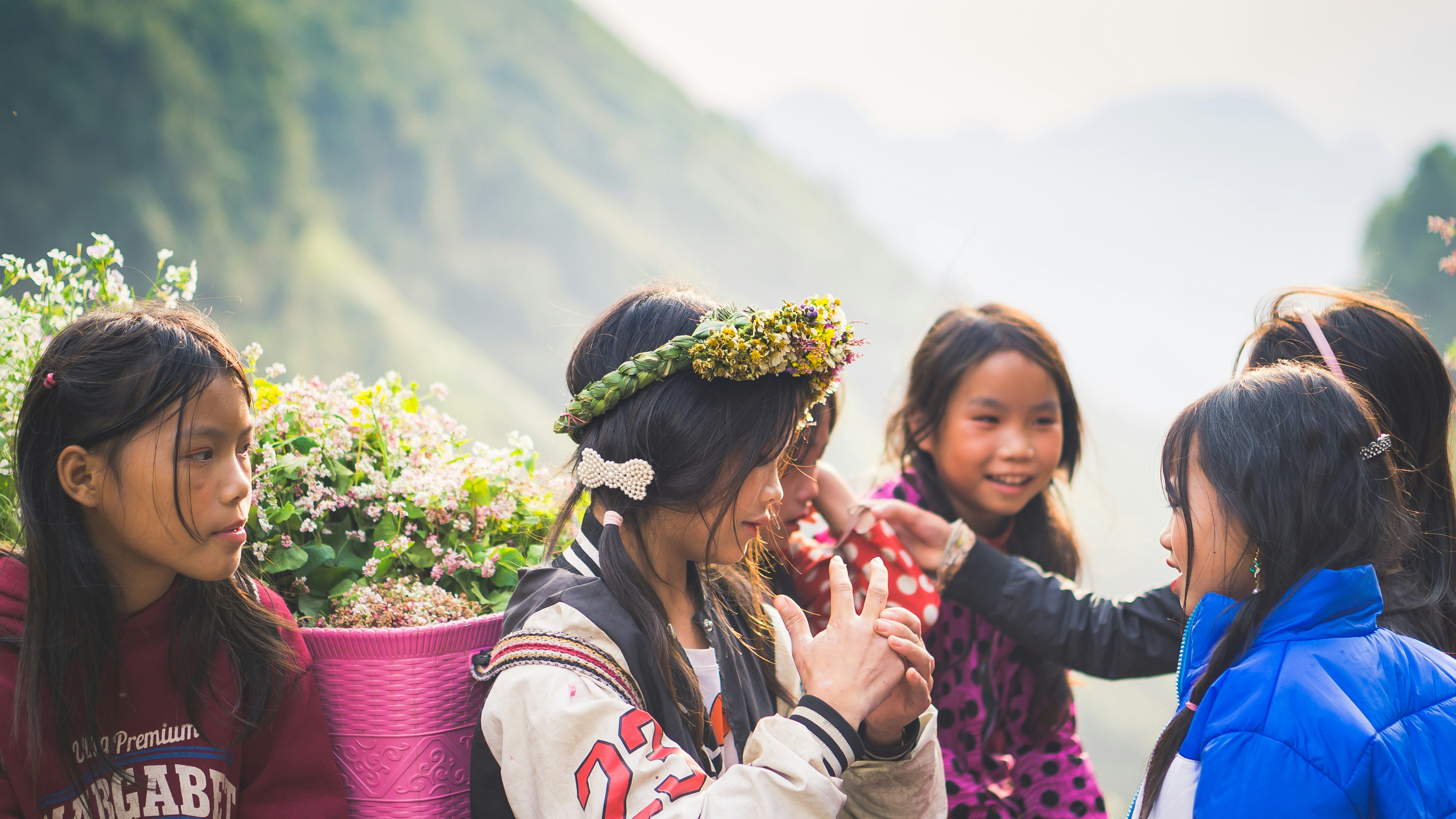 A group of young girls standing next to each other