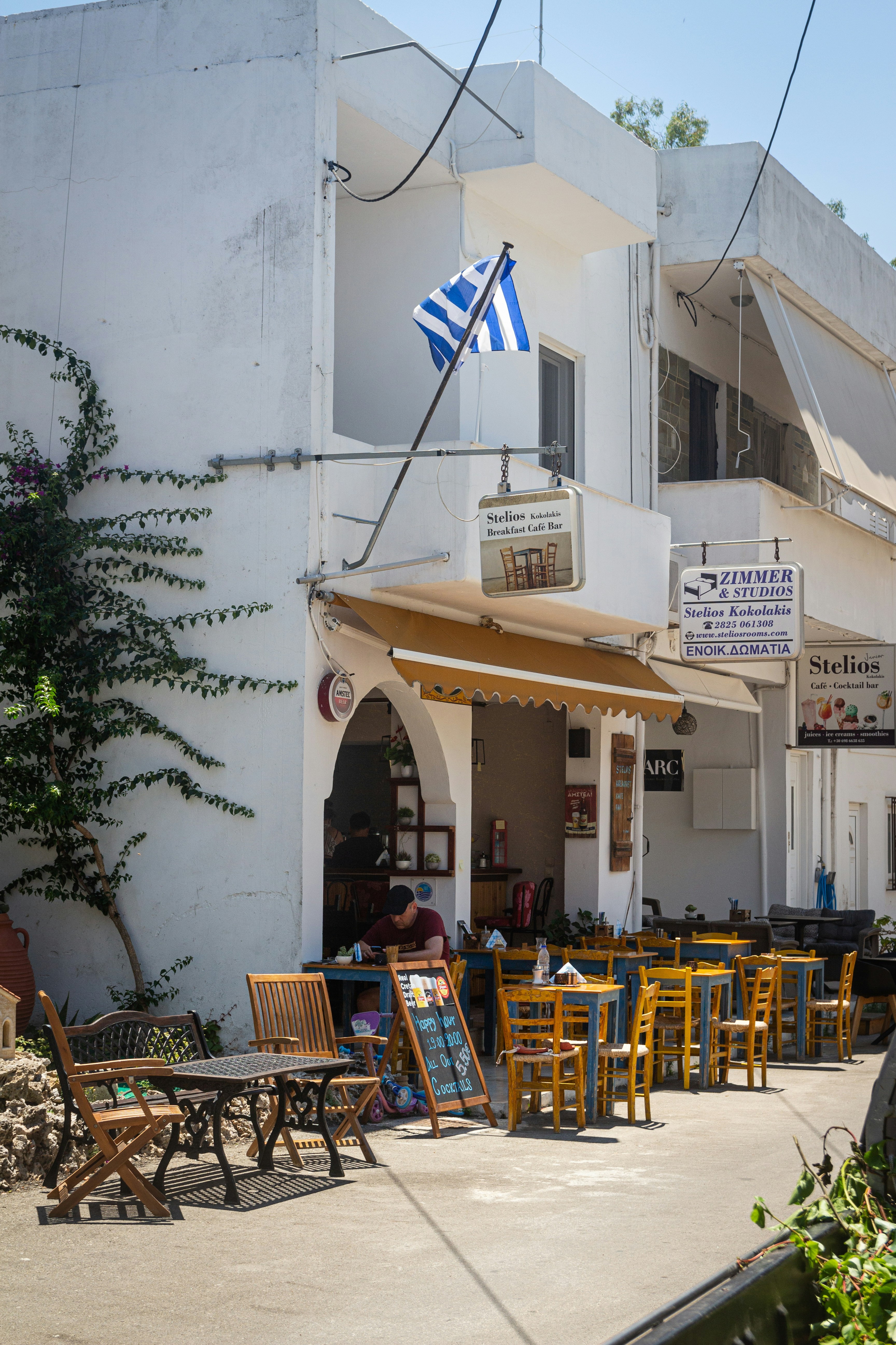 A building with tables and chairs in front of it