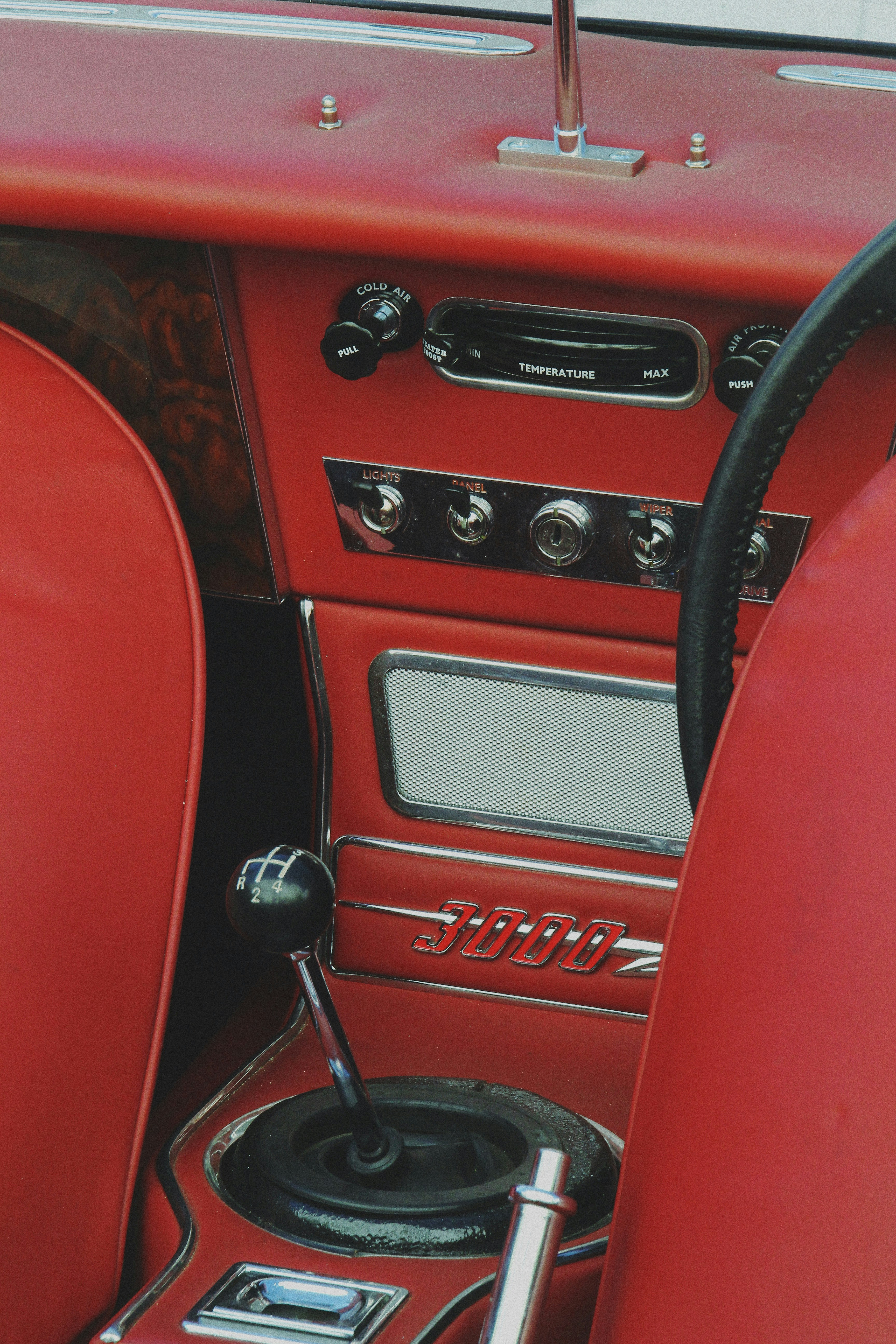 A red car dashboard with a steering wheel