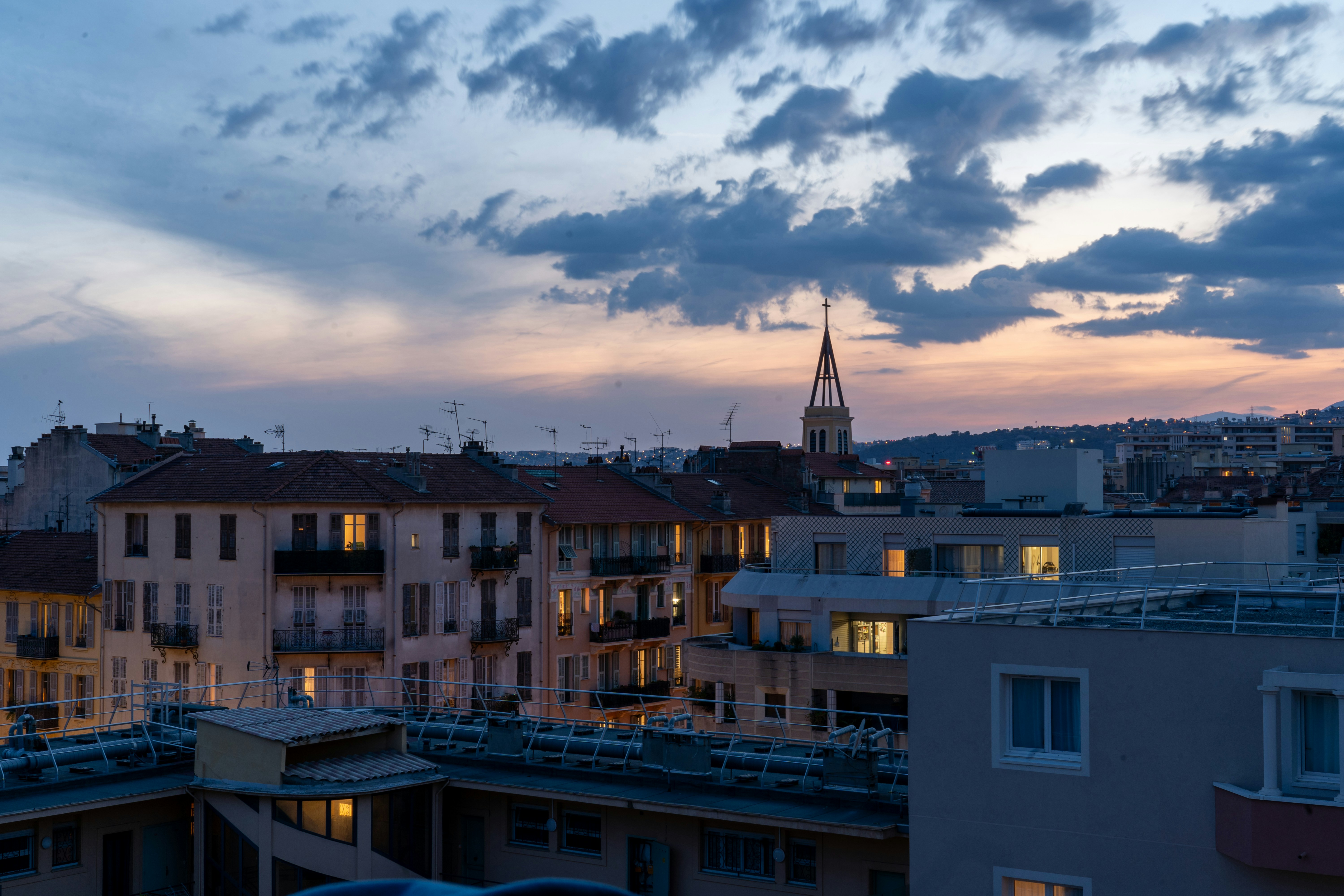 A view of a city from a rooftop at dusk