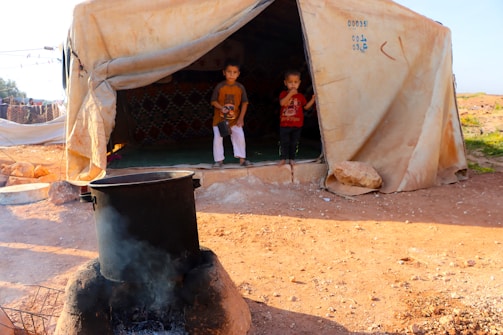 A group of people standing outside of a tent