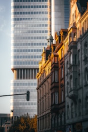A traffic light in front of a tall building