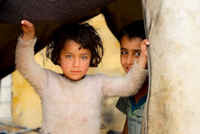 A couple of kids standing next to each other