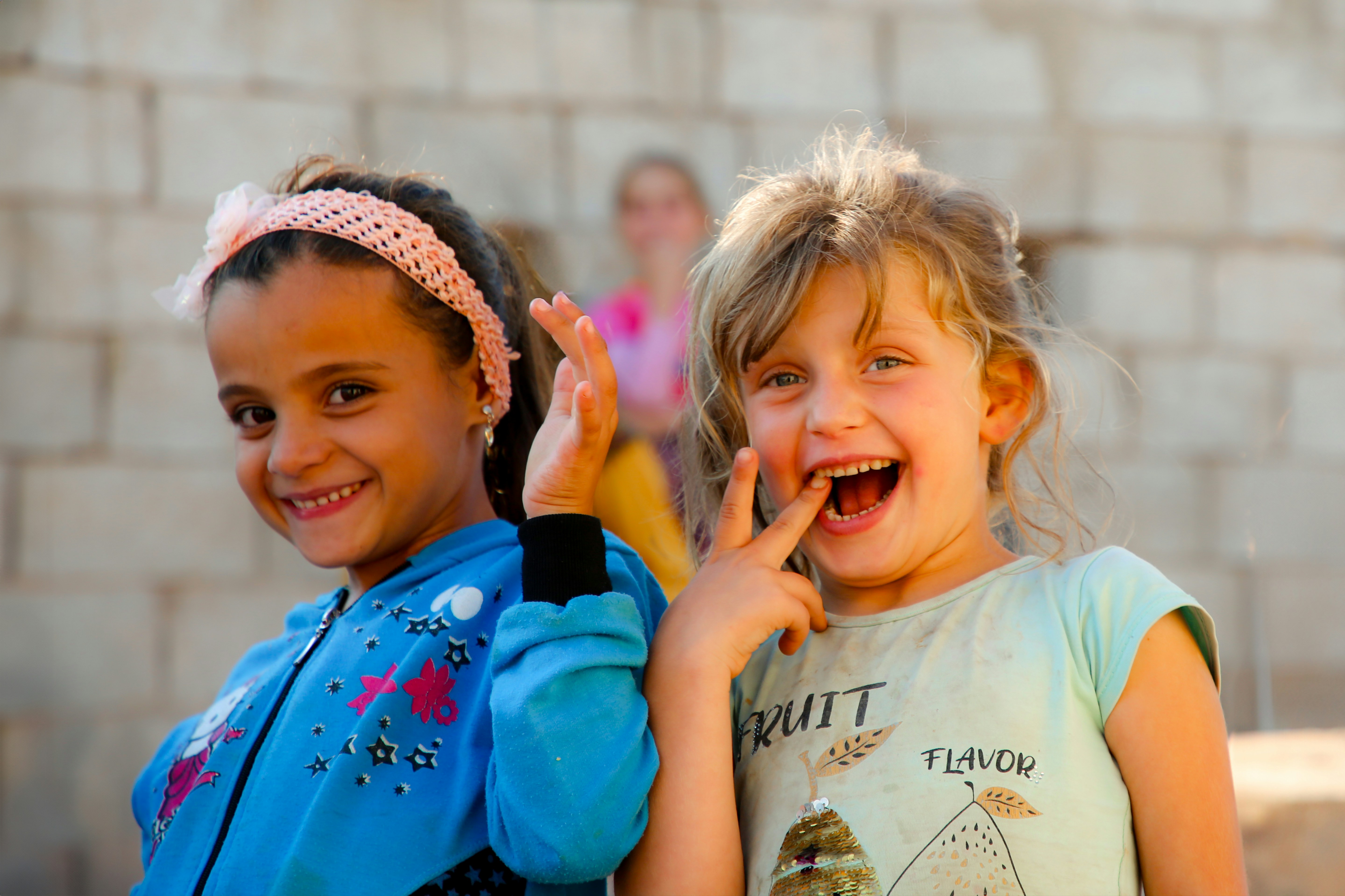 Two little girls standing next to each other
