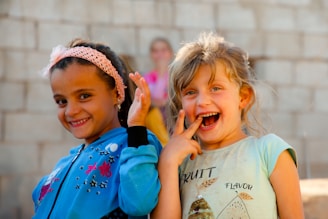 Two little girls standing next to each other