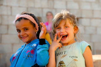 Two little girls standing next to each other