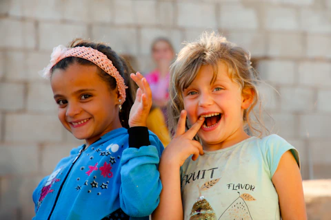 Two little girls standing next to each other