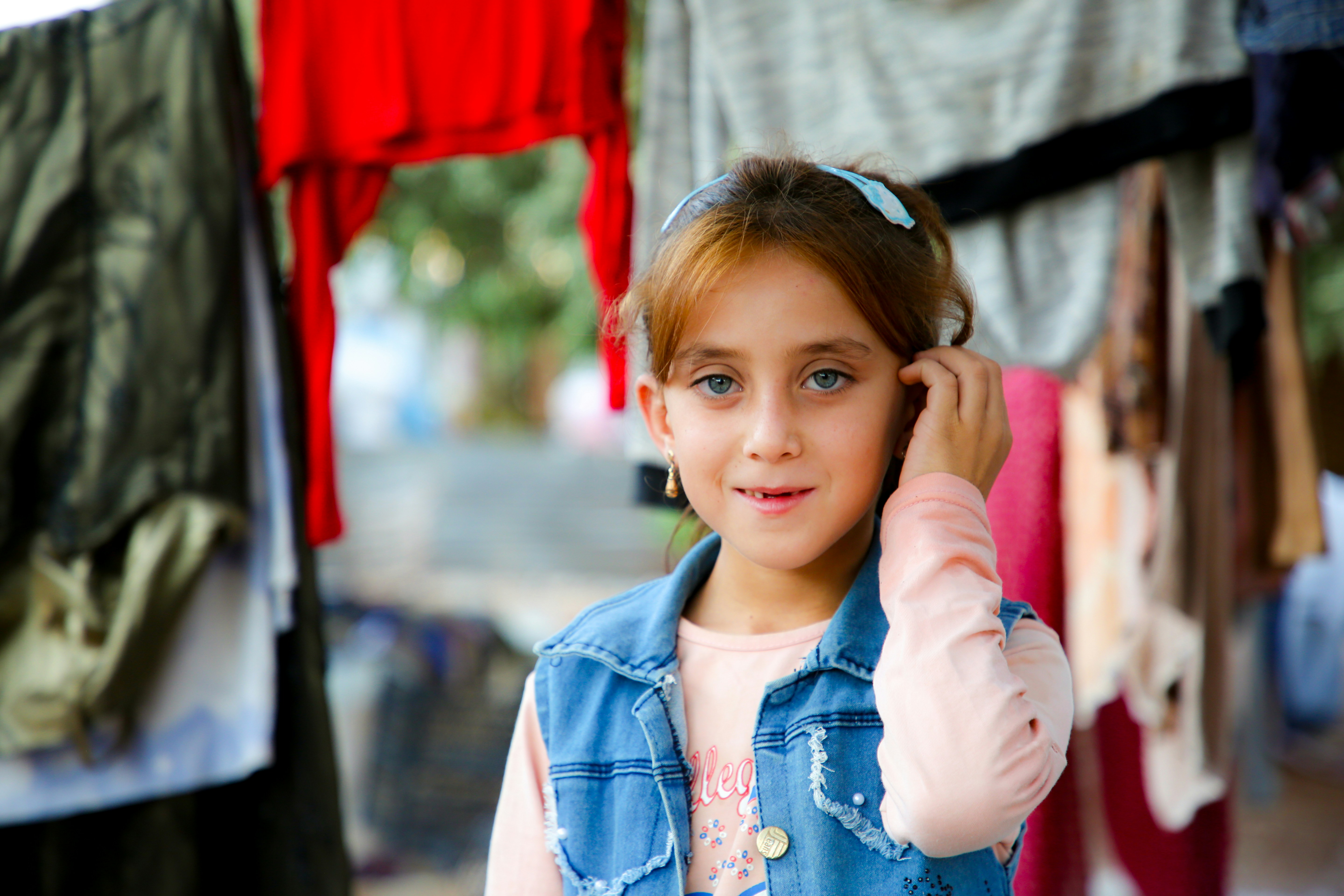 A young girl is talking on a cell phone