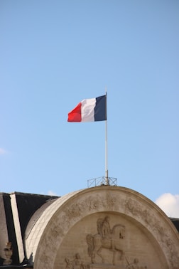 A flag flying on top of a building