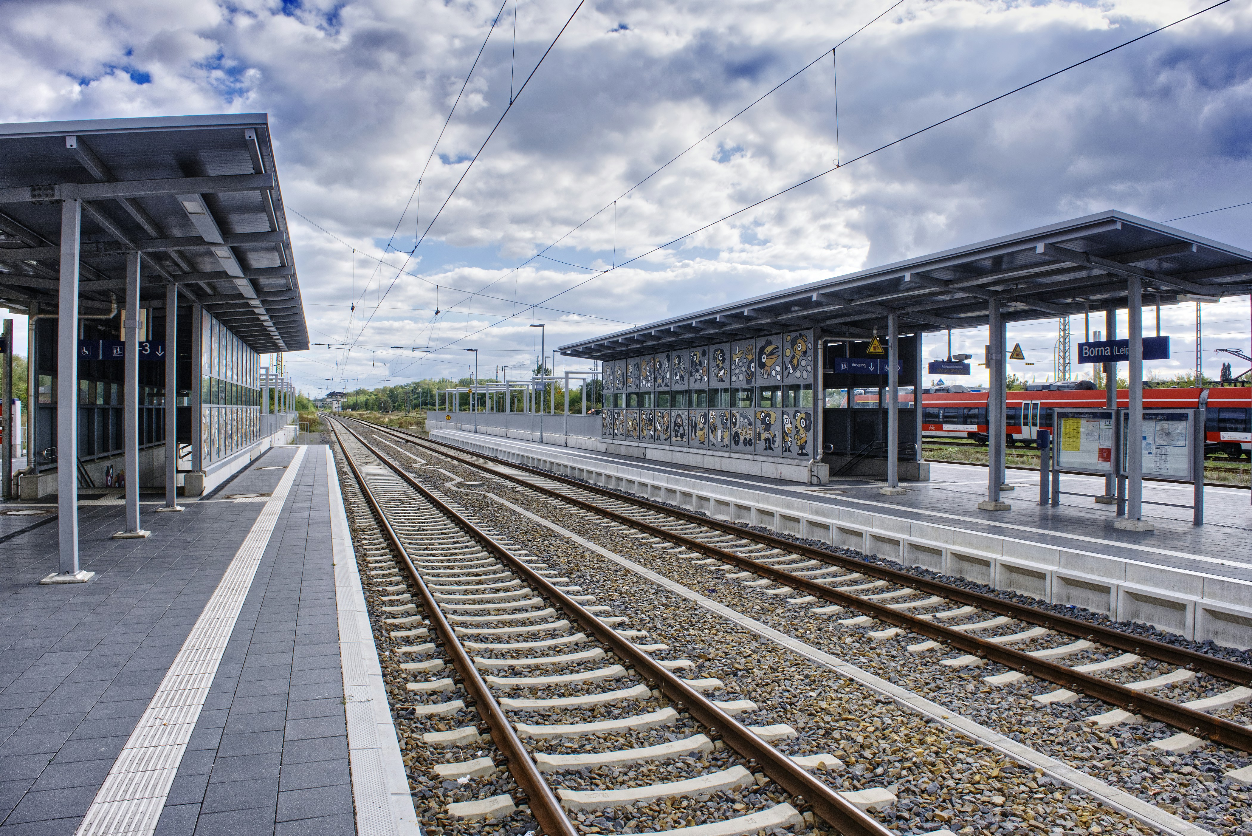 A train station with a train on the tracks