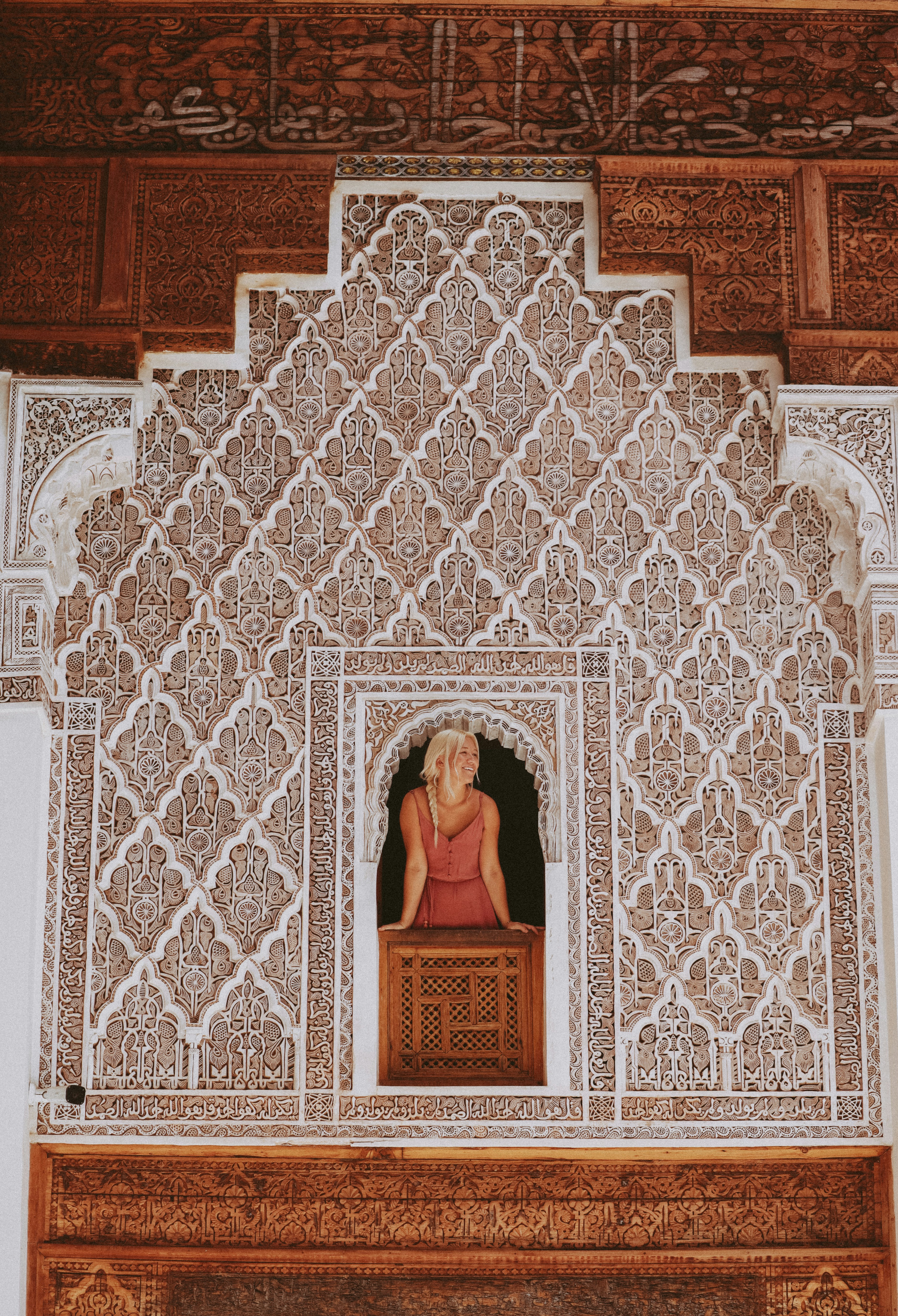 A woman in a red dress sitting in a window