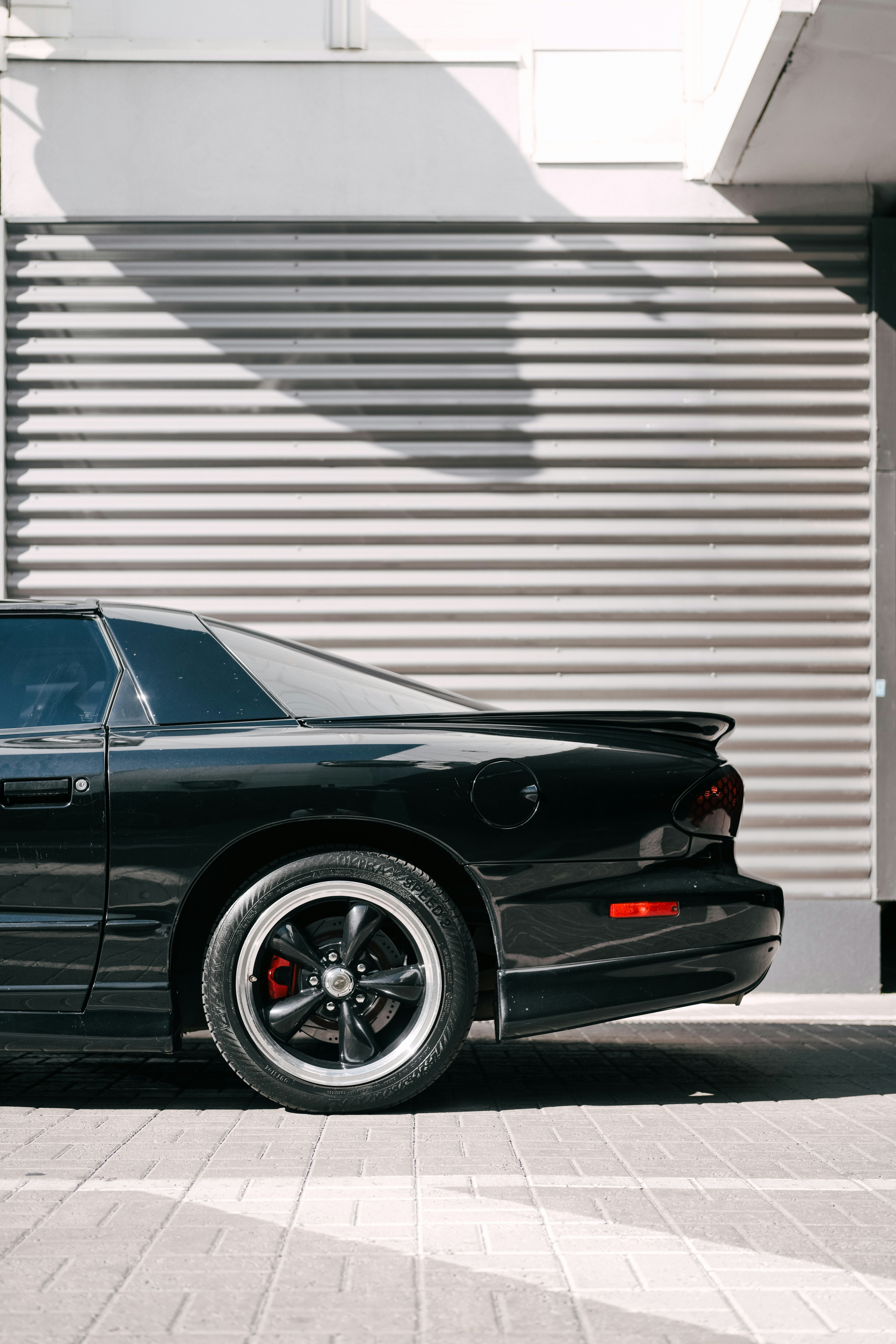 A black sports car parked in front of a building