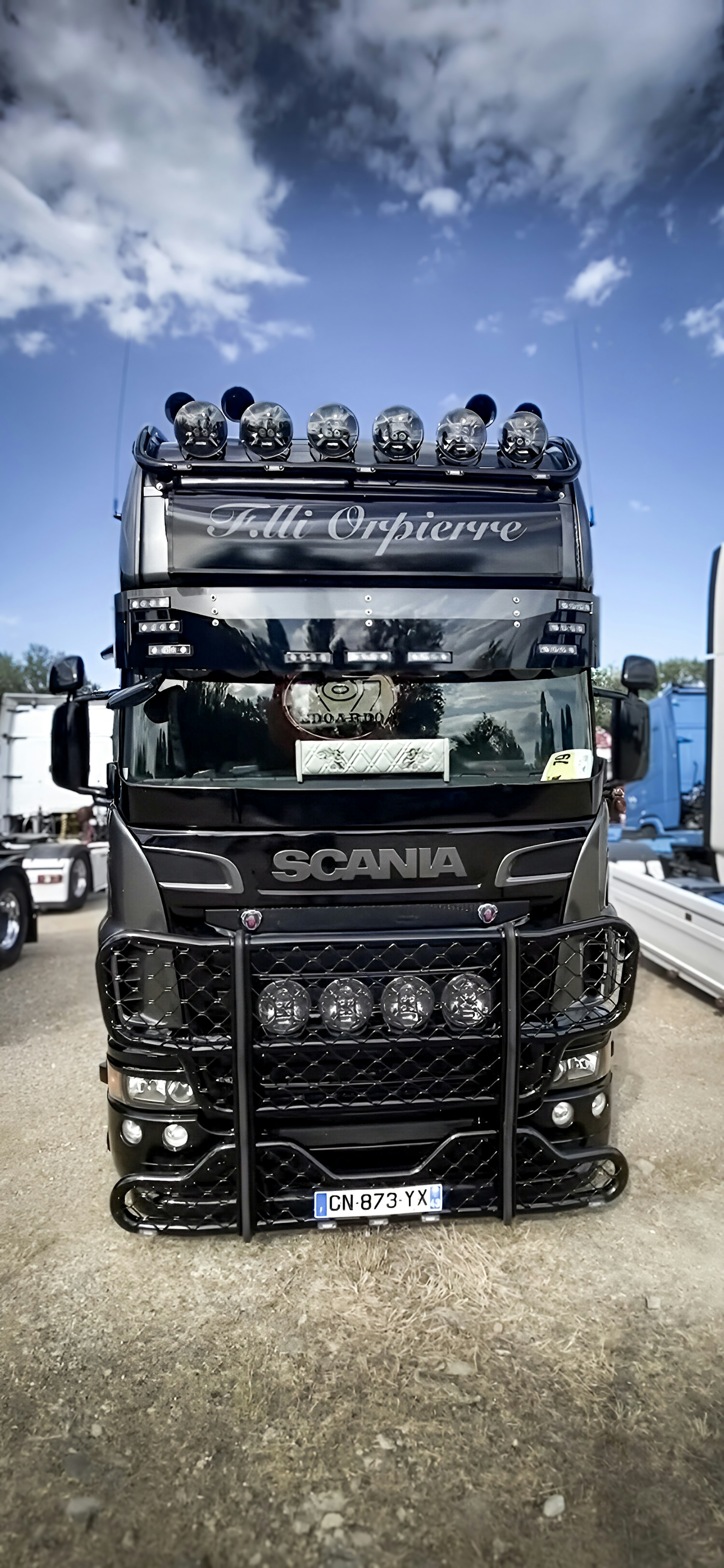 A large black truck parked in a parking lot