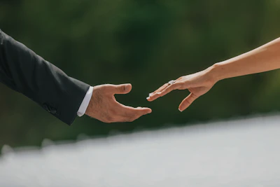 A close up of two people holding hands