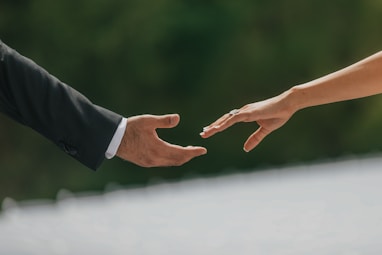 A close up of two people holding hands