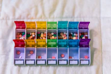 A bunch of plastic containers filled with different colored items