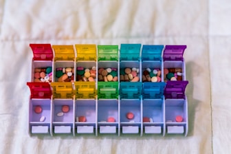 A bunch of plastic containers filled with different colored items