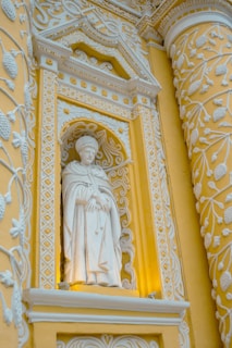 A statue of a woman in a yellow and white building